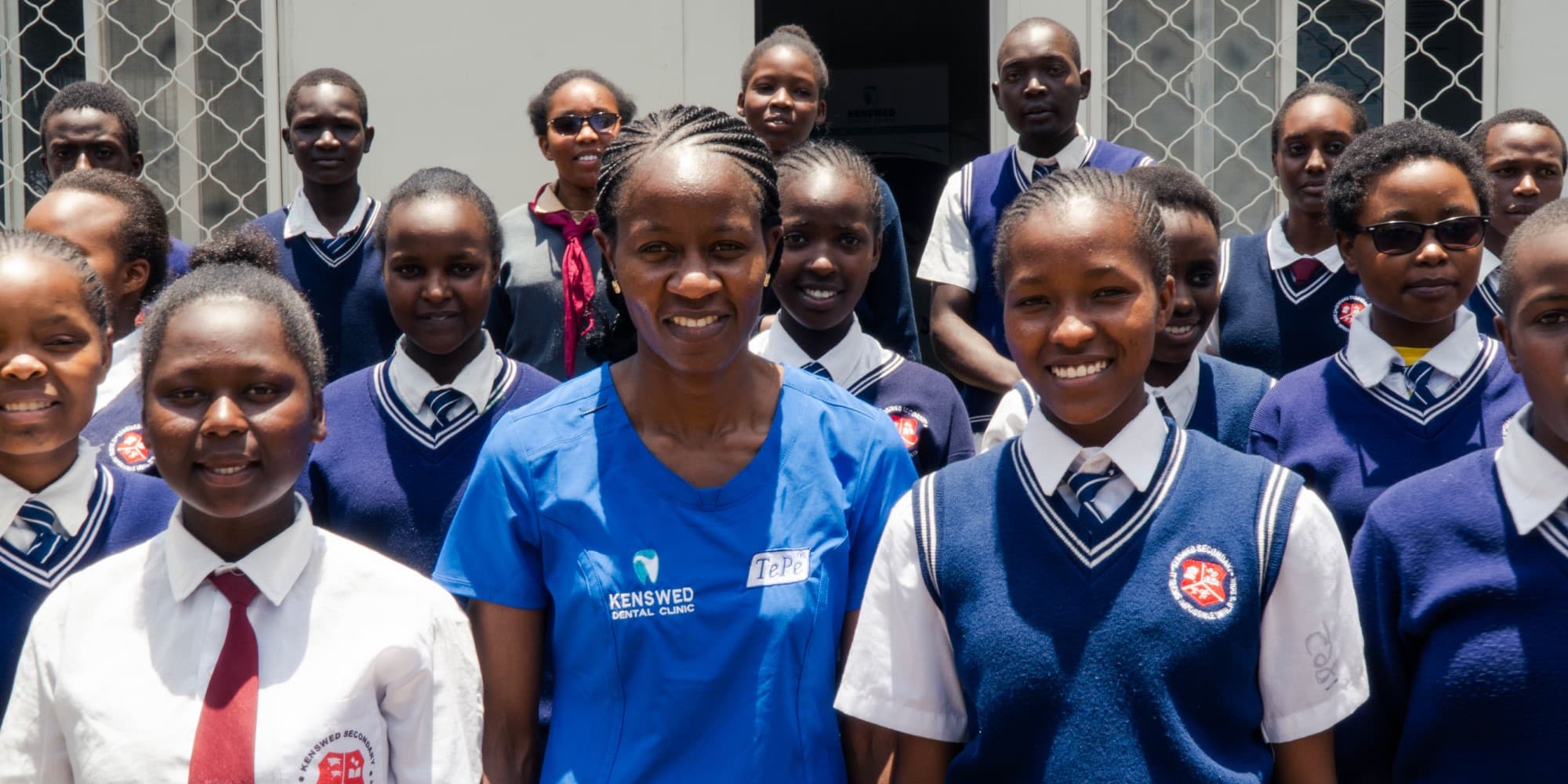 Image of a dentist and several school children