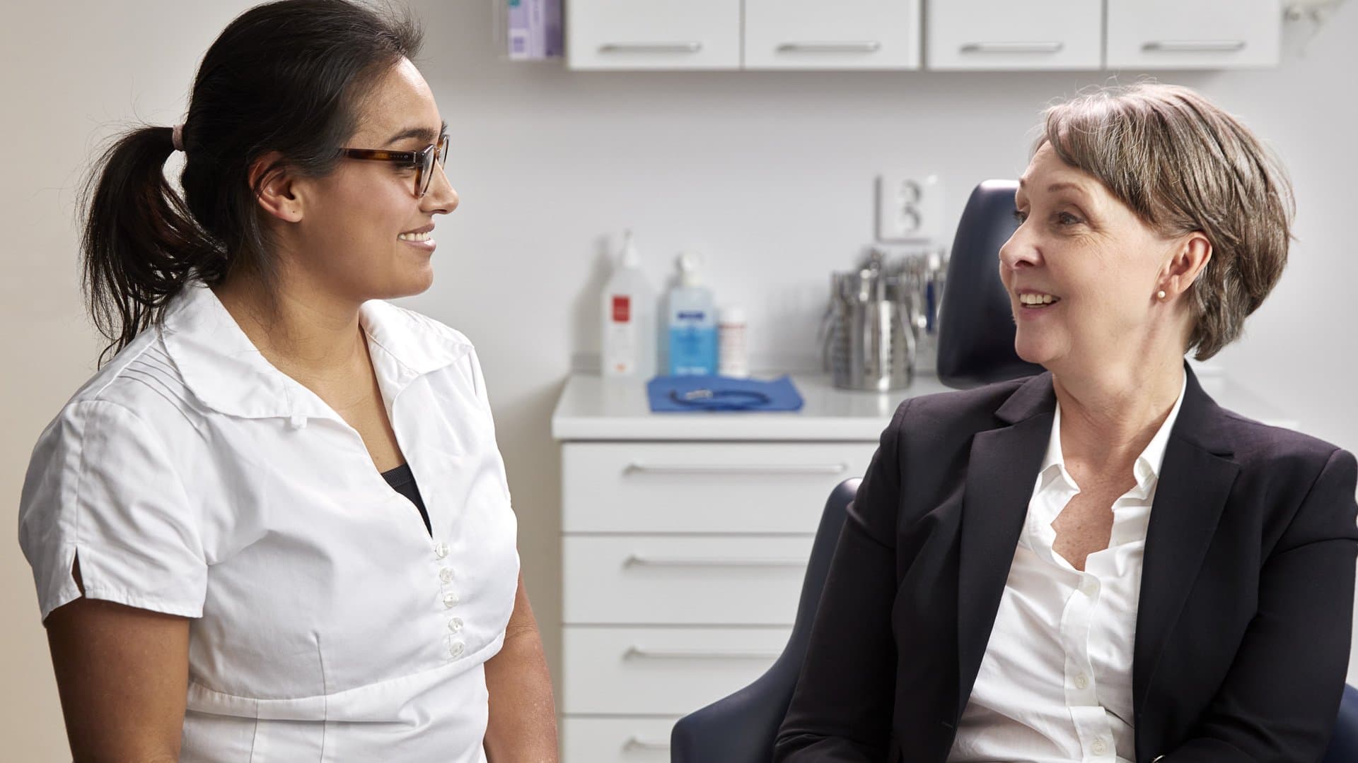 Dentist together with her middel aged patient